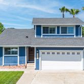 a front view of a house with a garden and yard