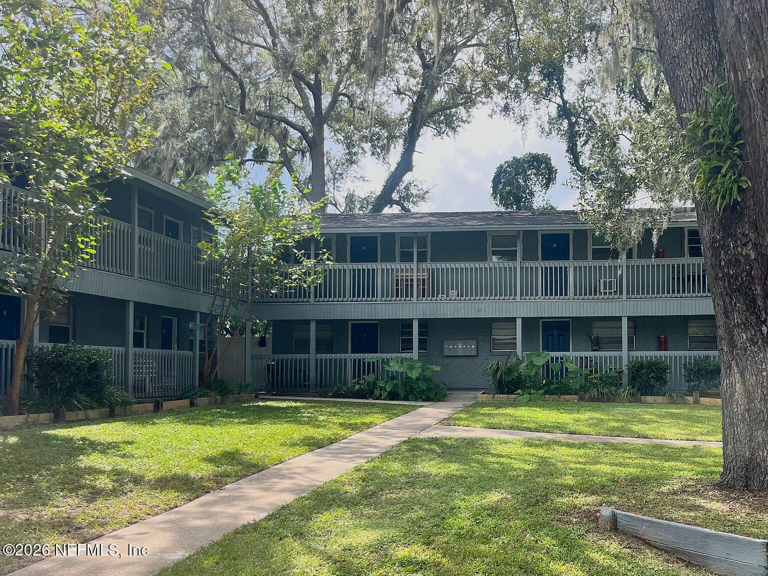 1040 Bert Road, Unit 12 Jacksonville, FL 32211 - Photo 1 of 1 a front view of a house with a yard table and chairs