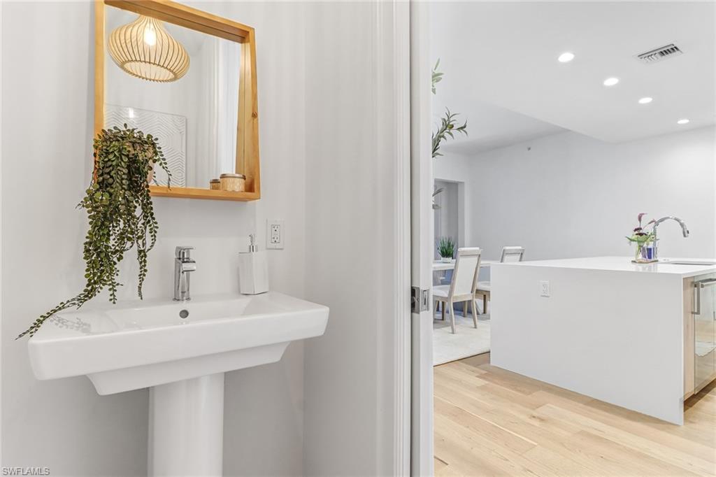 1115 Central Avenue, Unit 340 Naples, FL 34102 - Photo 14 of 39 a bathroom with a sink a mirror and a window
