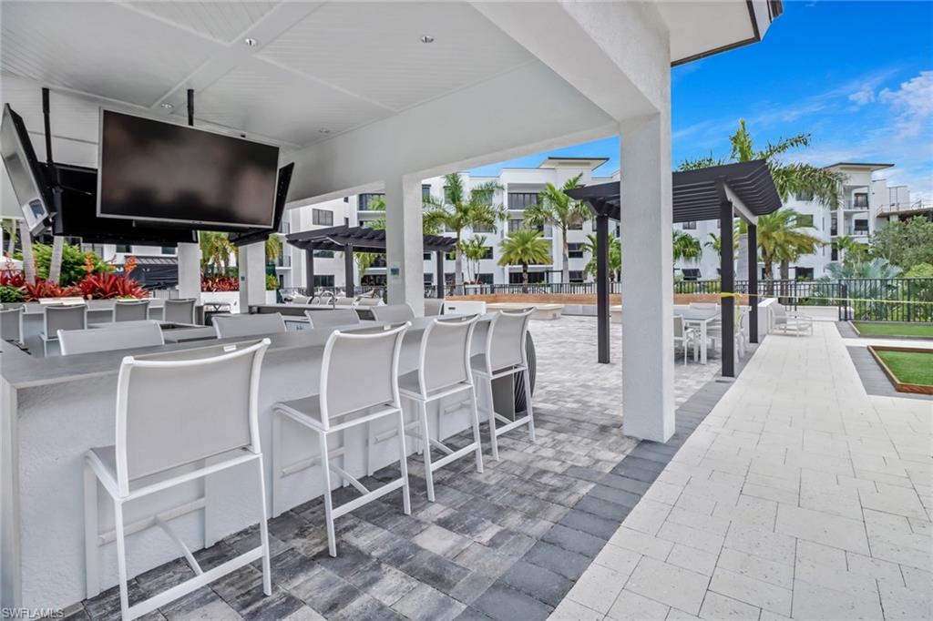 1115 Central Avenue, Unit 340 Naples, FL 34102 - Photo 20 of 39 a outdoor dining space with furniture