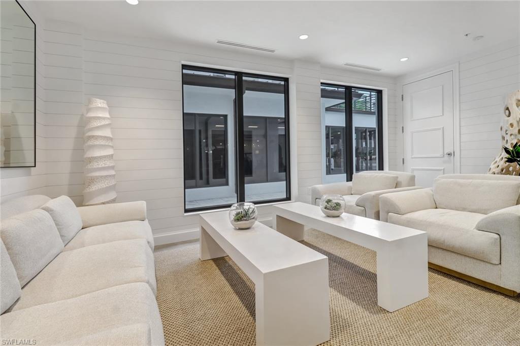 1115 Central Avenue, Unit 340 Naples, FL 34102 - Photo 23 of 39 a living room with furniture and large windows