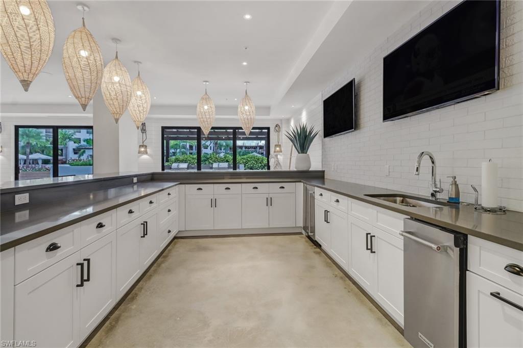 1115 Central Avenue, Unit 340 Naples, FL 34102 - Photo 24 of 39 a large white kitchen with stainless steel appliances granite countertop a sink and a microwave