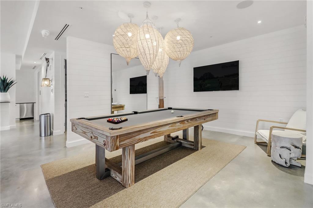 1115 Central Avenue, Unit 340 Naples, FL 34102 - Photo 27 of 39 a living room with furniture and a flat screen tv