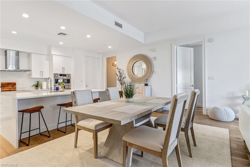 1115 Central Avenue, Unit 340 Naples, FL 34102 - Photo 3 of 39 a view of a dining room with furniture and a kitchen