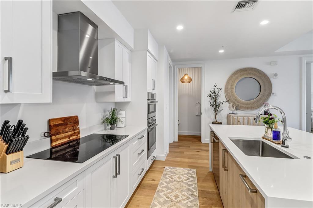 1115 Central Avenue, Unit 340 Naples, FL 34102 - Photo 39 of 39 a kitchen with stainless steel appliances granite countertop a sink a stove and cabinets