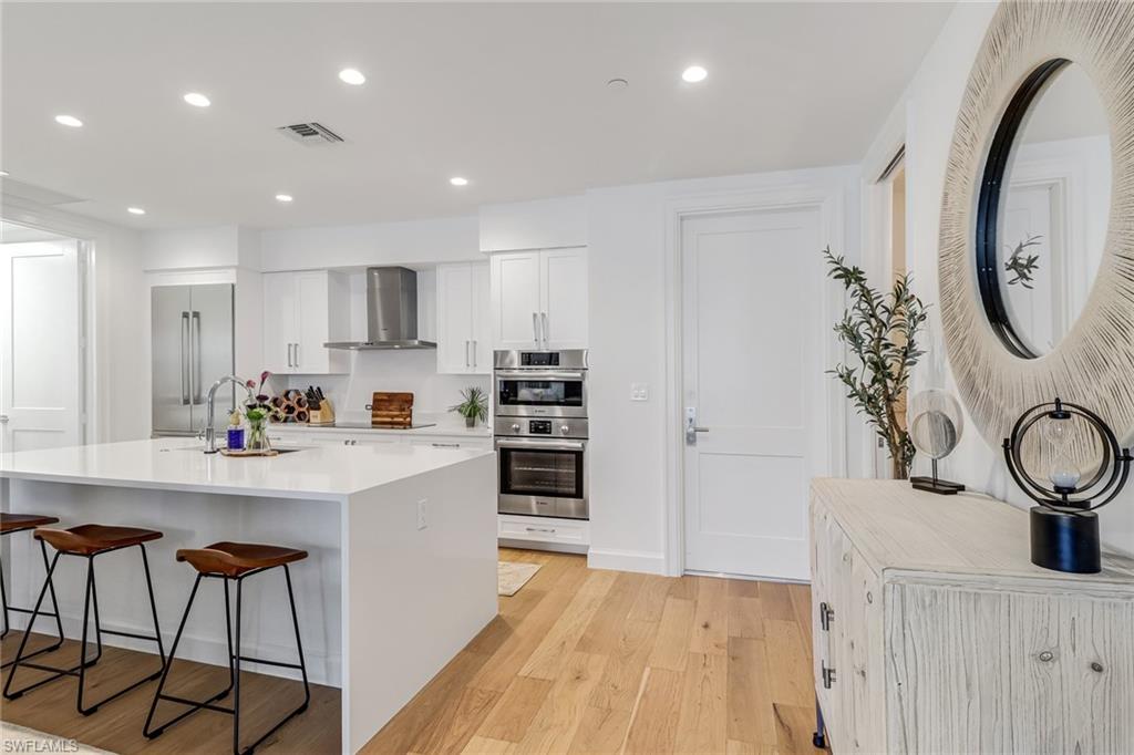1115 Central Avenue, Unit 340 Naples, FL 34102 - Photo 4 of 39 a kitchen with stainless steel appliances a stove a sink and a refrigerator