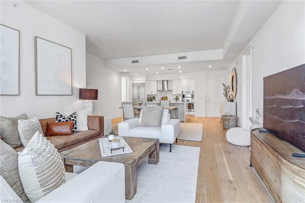 1115 Central Avenue, Unit 340 Naples, FL 34102 - Photo 6 of 39 a living room with furniture and a large window