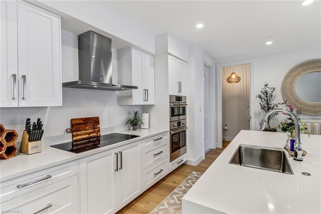 1115 Central Avenue, Unit 340 Naples, FL 34102 - Photo 7 of 39 a kitchen with stainless steel appliances granite countertop a sink a stove and cabinets