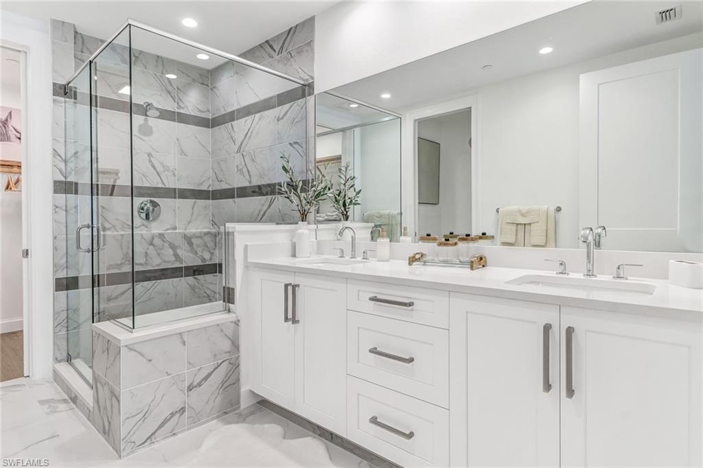 1115 Central Avenue, Unit 340 Naples, FL 34102 - Photo 9 of 39 a bathroom with a double vanity sink mirror and shower