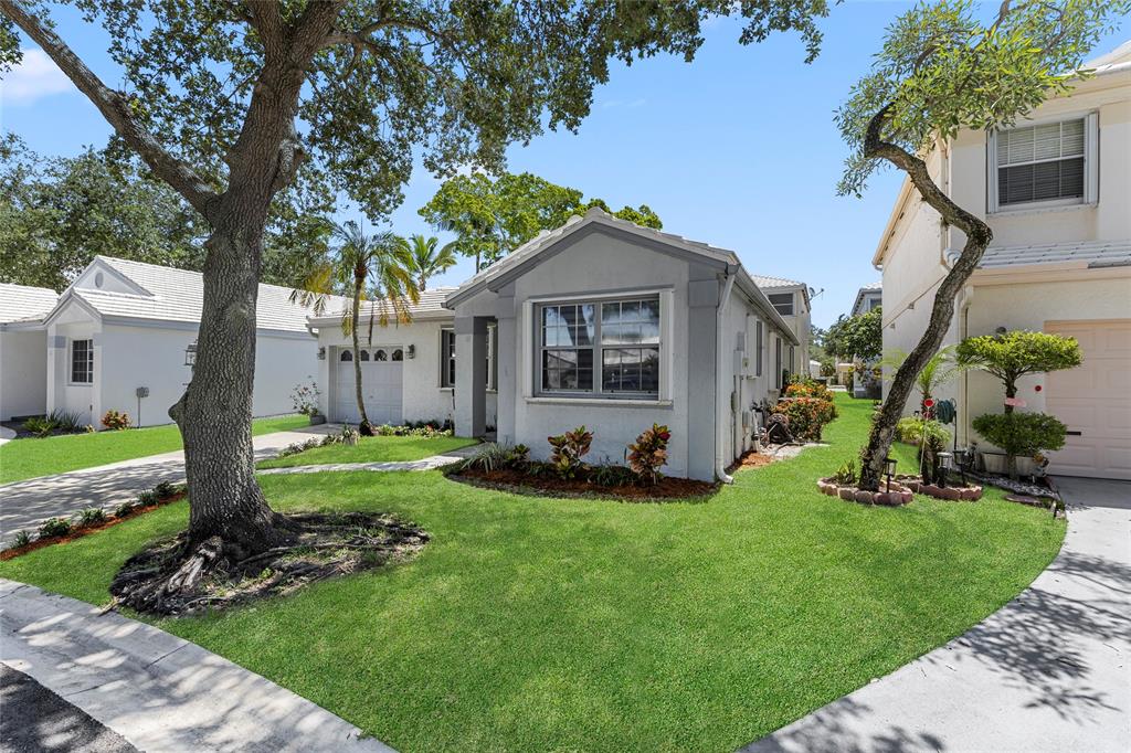 9424 Northwest 8th Circle Plantation, FL 33324 - Photo 14 of 57 a front view of house with yard and green space