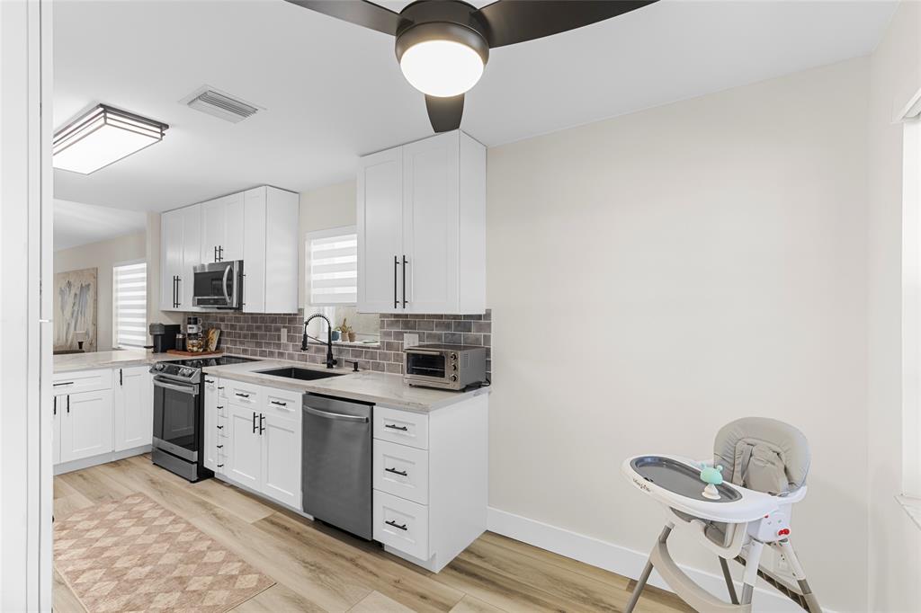 9424 Northwest 8th Circle Plantation, FL 33324 - Photo 23 of 57 a kitchen with a sink cabinets and window