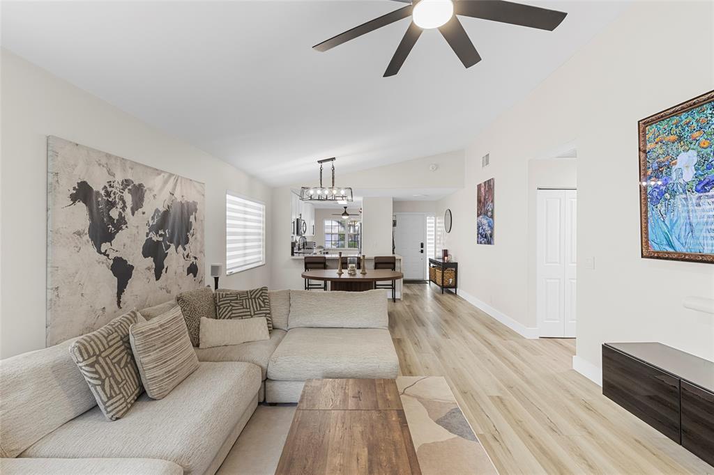 9424 Northwest 8th Circle Plantation, FL 33324 - Photo 27 of 57 a living room with furniture and a chandelier