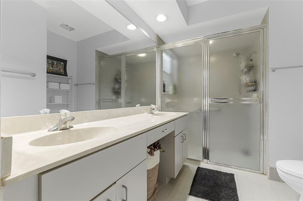 9424 Northwest 8th Circle Plantation, FL 33324 - Photo 36 of 57 a bathroom with a shower sink vanity mirror and toilet