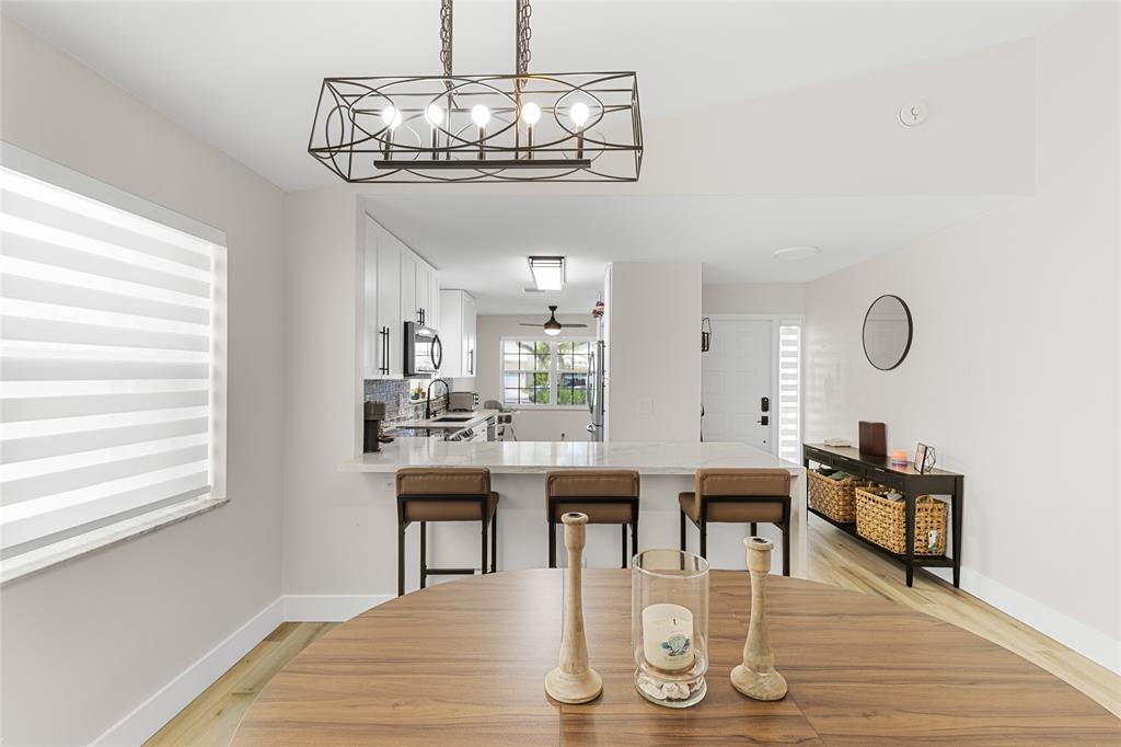 9424 Northwest 8th Circle Plantation, FL 33324 - Photo 8 of 57 a view of a dining room with furniture wooden floor and chandelier