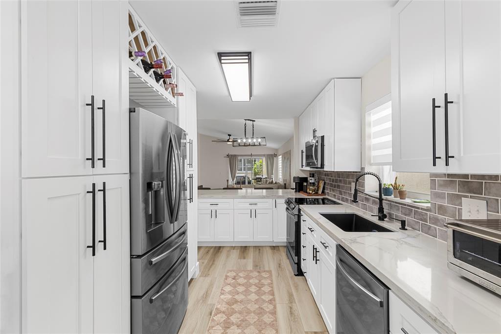 9424 Northwest 8th Circle Plantation, FL 33324 - Photo 10 of 57 a kitchen with a sink stove and refrigerator