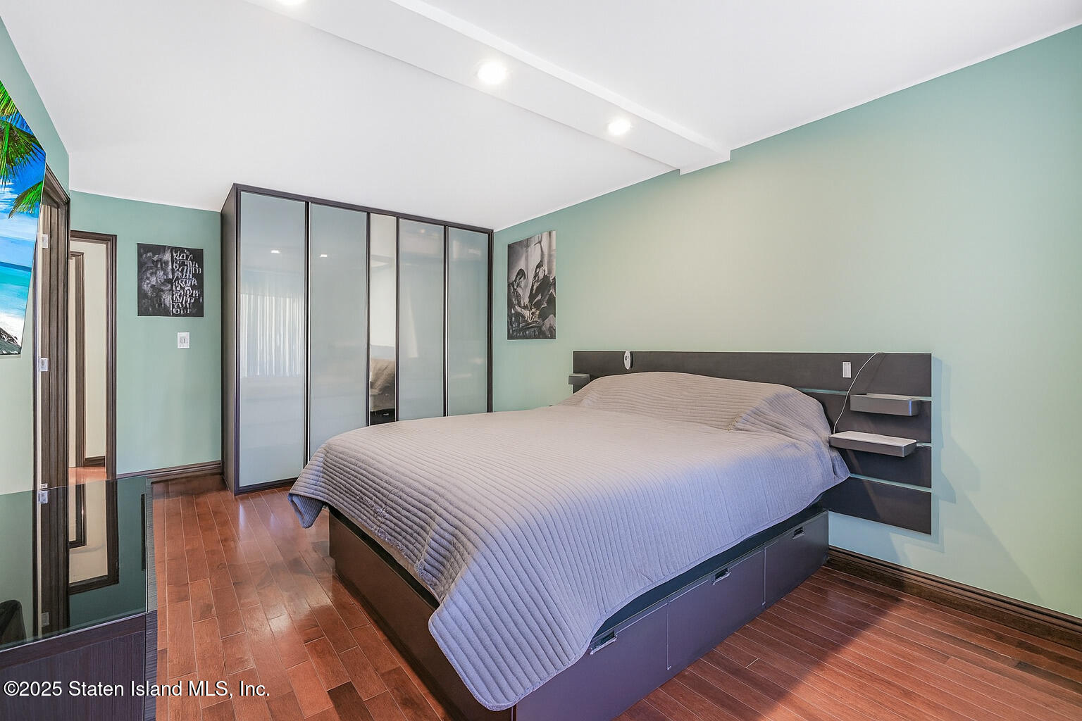 40 Wellington Court, Unit 2A Staten Island, NY 10314 - Photo 13 of 20 a bedroom with a bed and a night stand