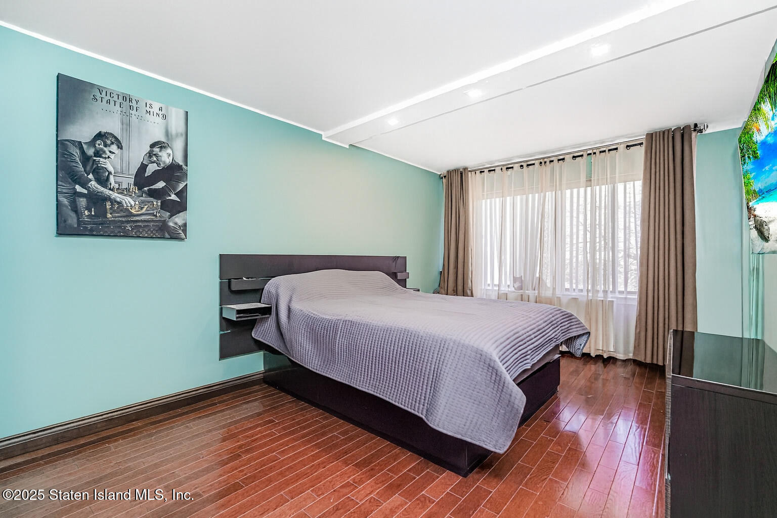 40 Wellington Court, Unit 2A Staten Island, NY 10314 - Photo 14 of 20 a bedroom with a bed and a painting on the wall