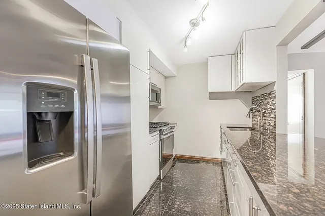 a kitchen with a refrigerator and a stove