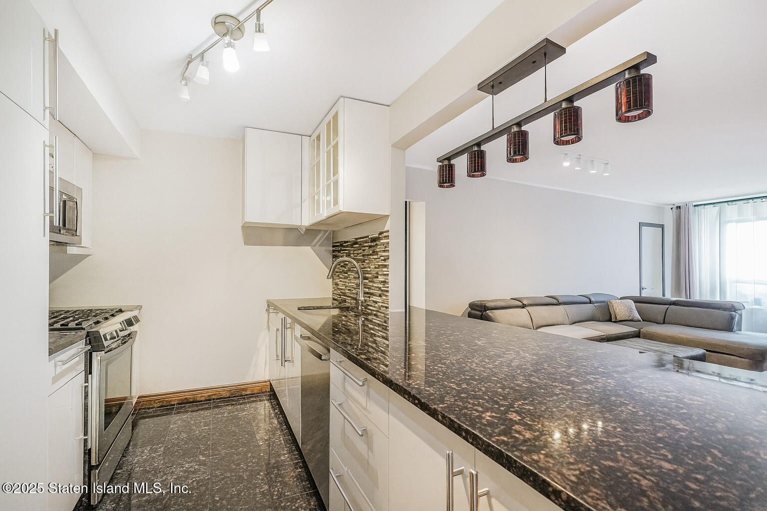 40 Wellington Court, Unit 2A Staten Island, NY 10314 - Photo 6 of 20 a kitchen with granite countertop a sink and a stove