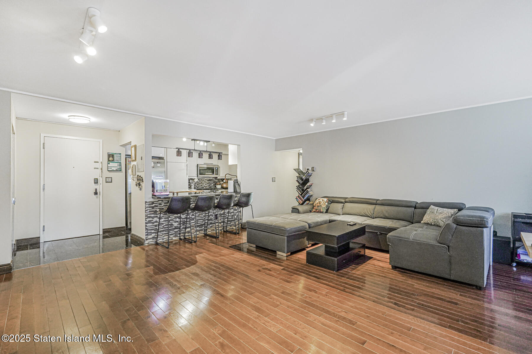 40 Wellington Court, Unit 2A Staten Island, NY 10314 - Photo 9 of 20 a living room with furniture and wooden floor