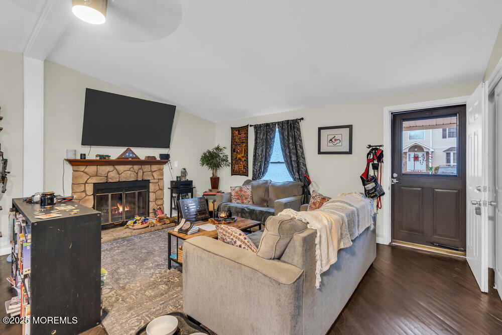 6 Mizzen Way Waretown, NJ 08758 - Photo 4 of 12 a living room with furniture a fireplace and a flat screen tv