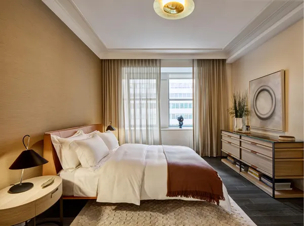 a spacious bedroom with a bed and window