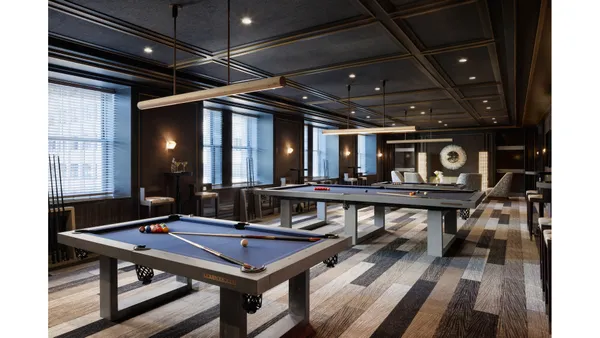 a room with furniture pool table table tennis table and a chandelier