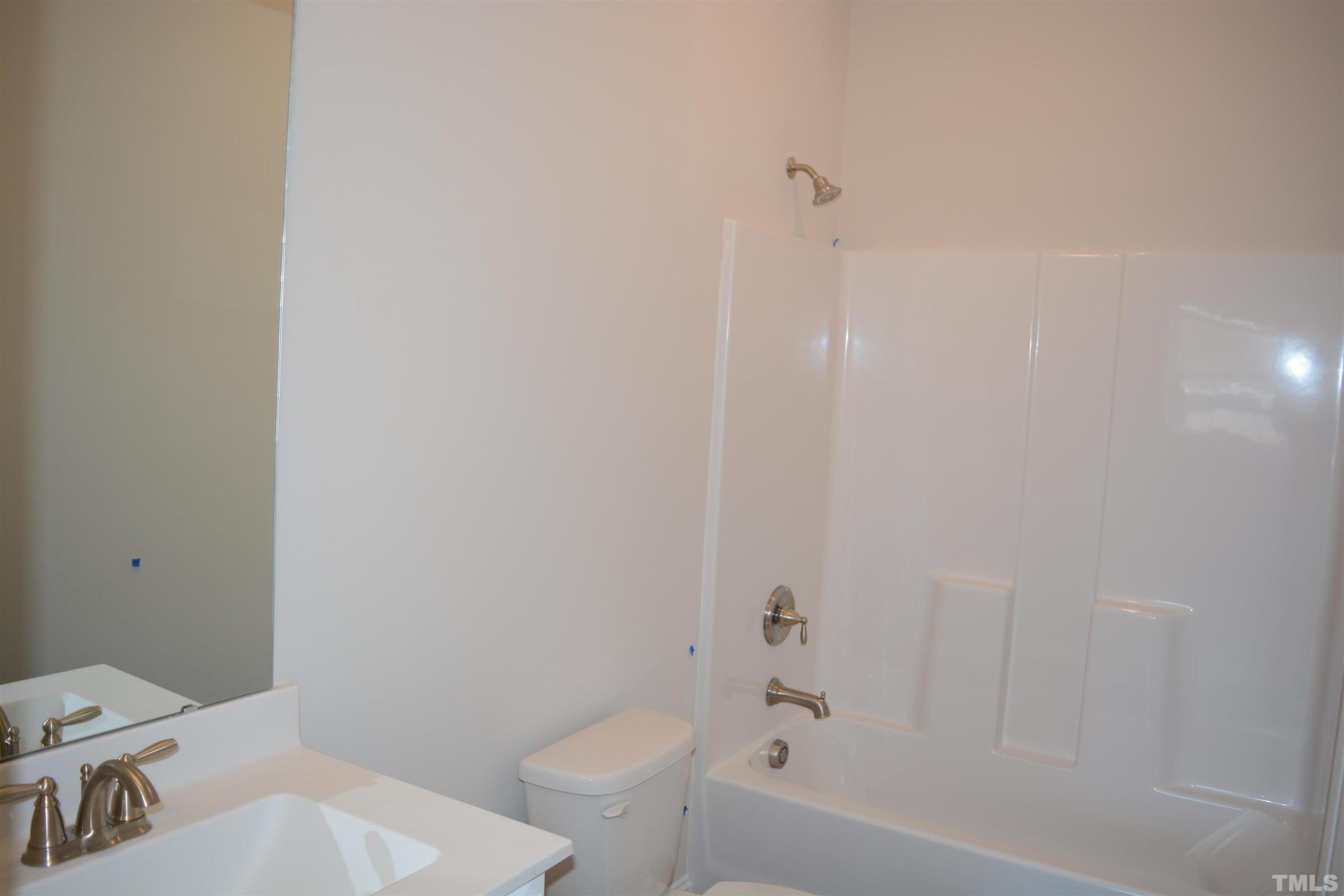 45 Level Drive Youngsville, NC 27596 - Photo 5 of 7 a bathroom with a toilet and a bathtub