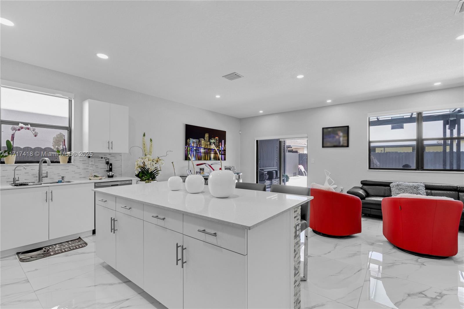12953 Southwest 230th Street Miami, FL 33170 - Photo 11 of 49 a kitchen with stainless steel appliances kitchen island granite countertop a sink and cabinets