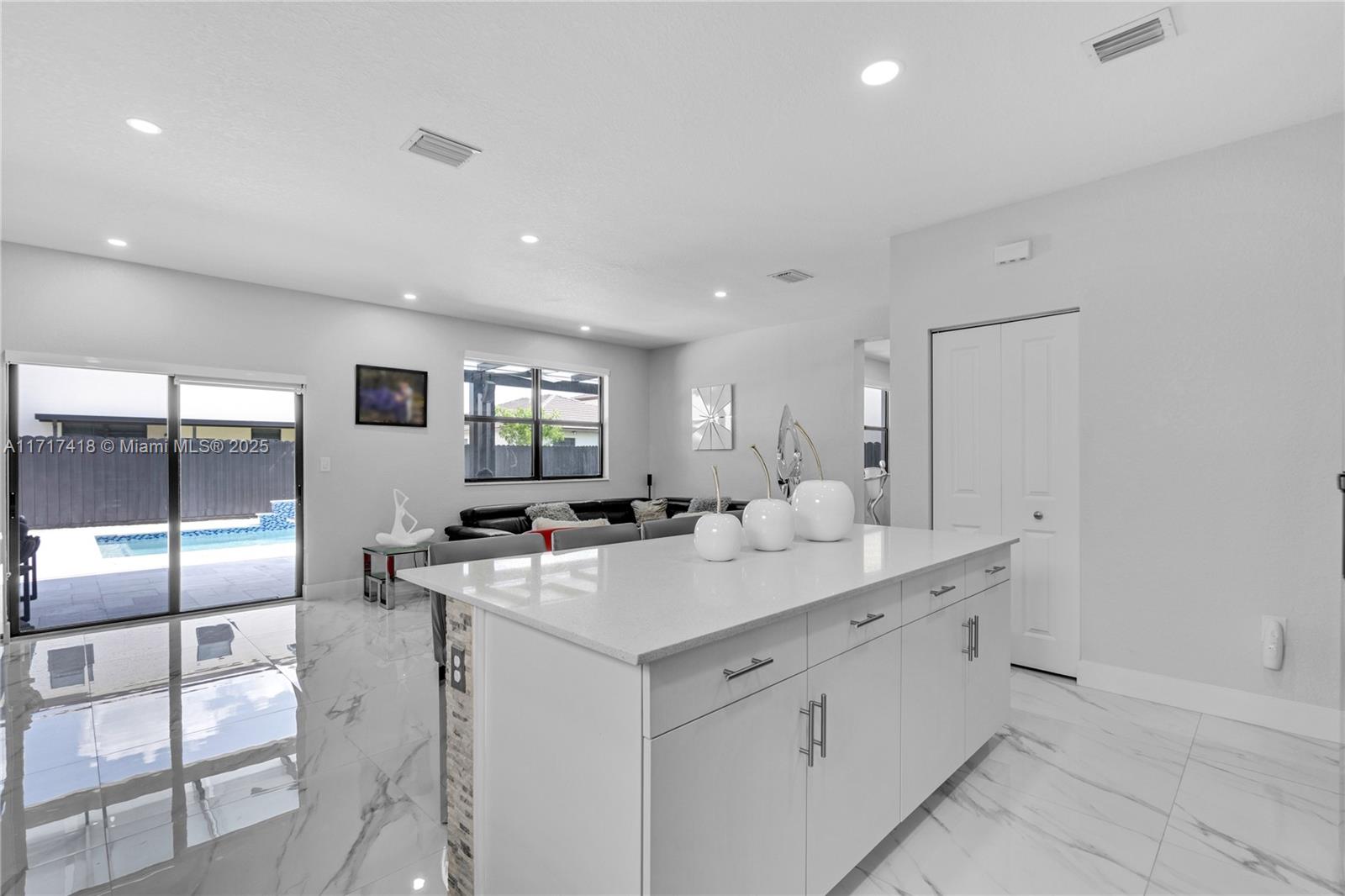 12953 Southwest 230th Street Miami, FL 33170 - Photo 13 of 49 a kitchen with sink and white cabinets