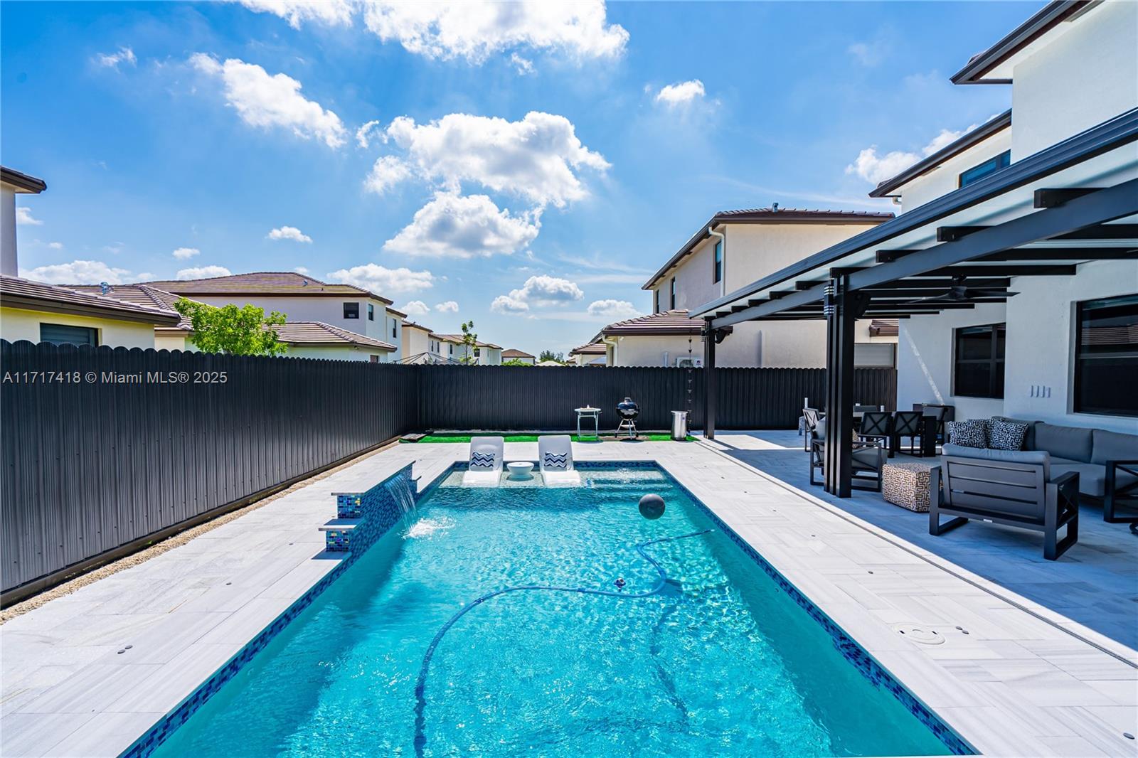 12953 Southwest 230th Street Miami, FL 33170 - Photo 17 of 49 a view of swimming pool with seating area and furniture