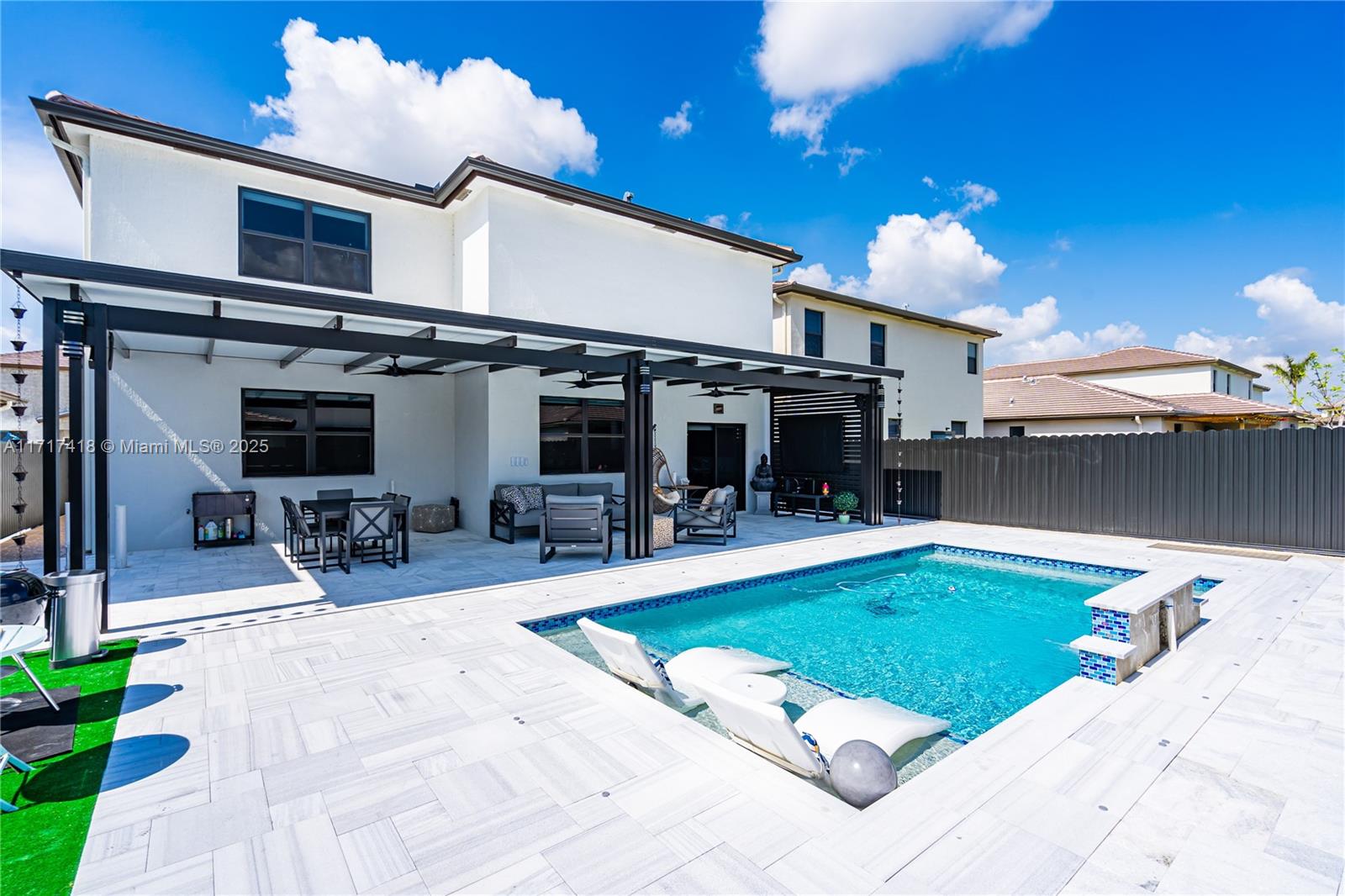 12953 Southwest 230th Street Miami, FL 33170 - Photo 18 of 49 a view of a swimming pool with outdoor seating