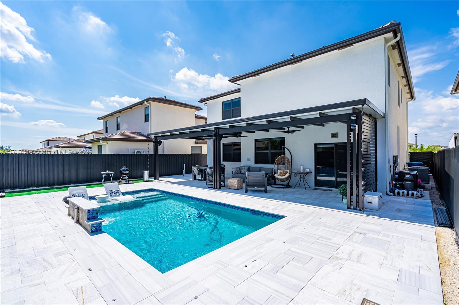 12953 Southwest 230th Street Miami, FL 33170 - Photo 19 of 49 a view of a swimming pool with outdoor seating and a patio