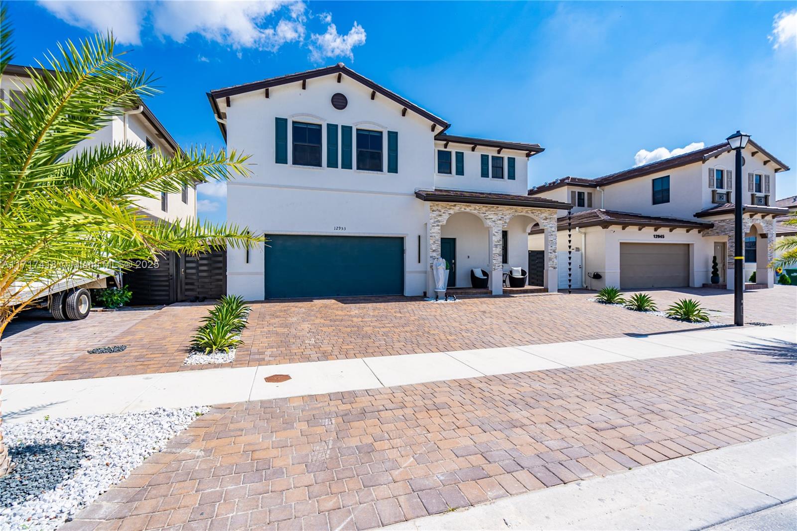 12953 Southwest 230th Street Miami, FL 33170 - Photo 2 of 49 a front view of a house with a yard