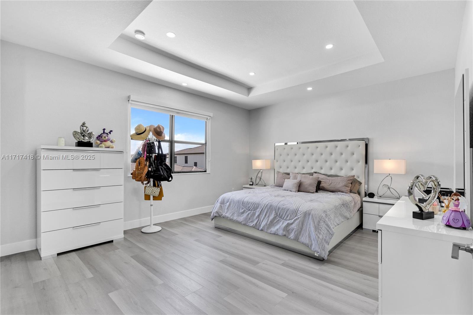 12953 Southwest 230th Street Miami, FL 33170 - Photo 21 of 49 a bedroom with a bed and a dresser