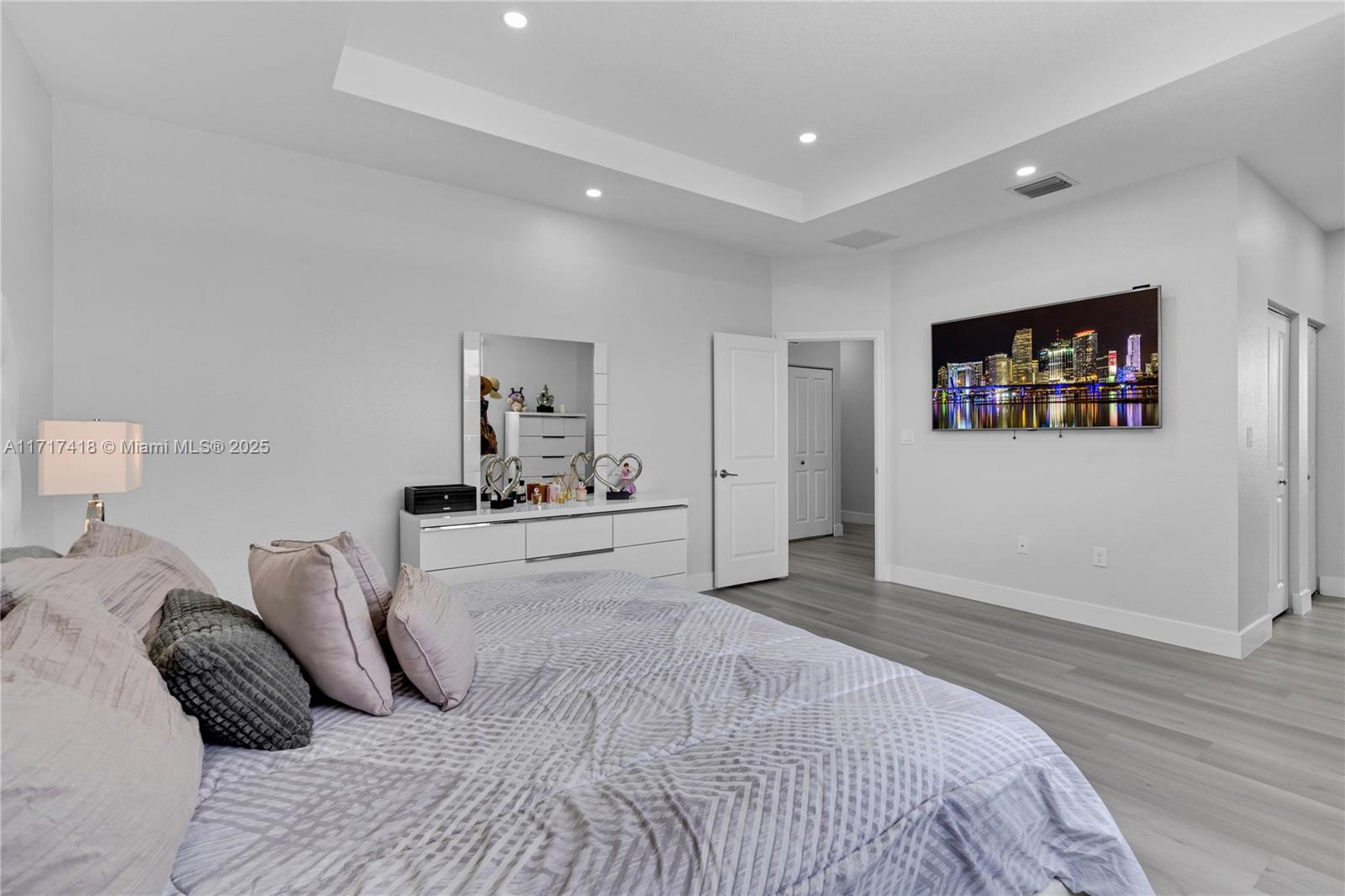 12953 Southwest 230th Street Miami, FL 33170 - Photo 22 of 49 a spacious bedroom with a bed and glass wall