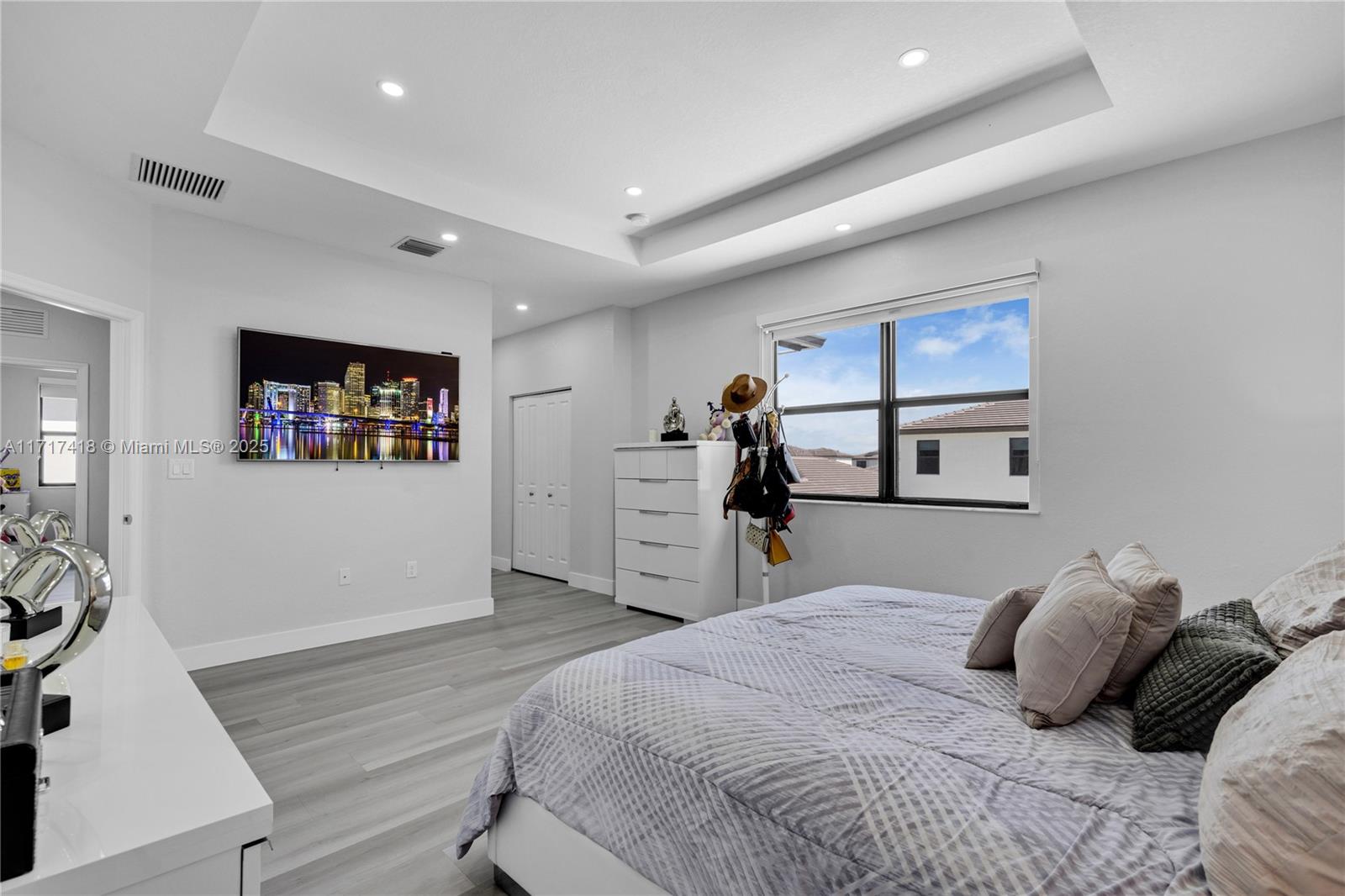 12953 Southwest 230th Street Miami, FL 33170 - Photo 23 of 49 a bedroom with a large bed and a flat tv screen