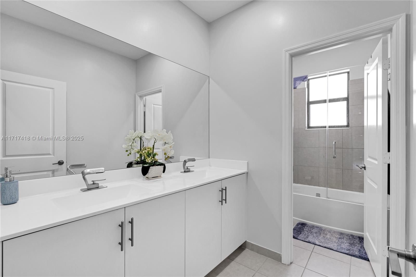 12953 Southwest 230th Street Miami, FL 33170 - Photo 28 of 49 a bathroom with a sink and a mirror