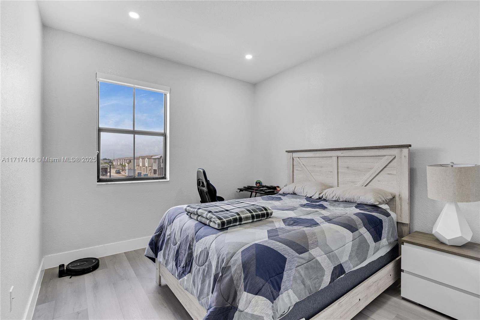 12953 Southwest 230th Street Miami, FL 33170 - Photo 29 of 49 a bedroom with a bed and a window