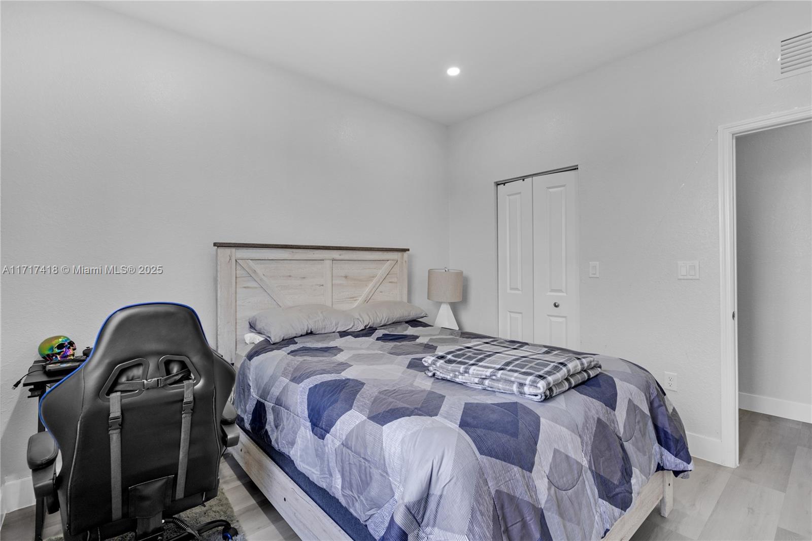 12953 Southwest 230th Street Miami, FL 33170 - Photo 30 of 49 a bedroom with a bed and wooden floor