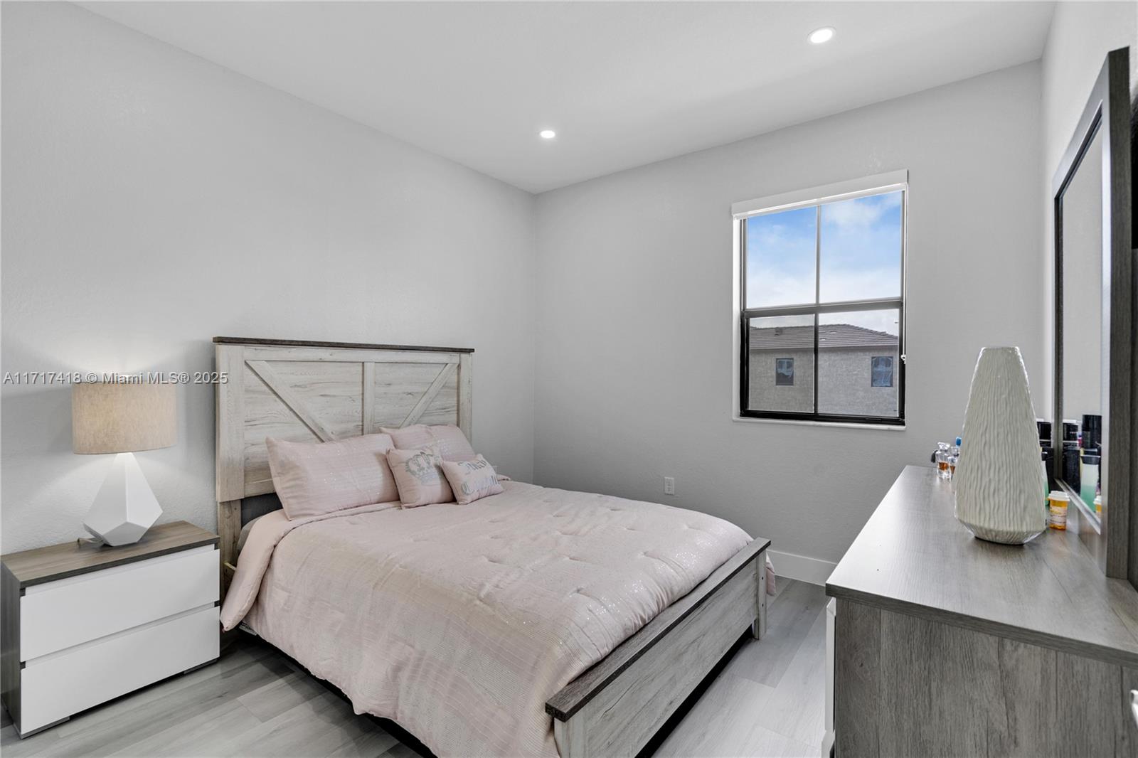 12953 Southwest 230th Street Miami, FL 33170 - Photo 31 of 49 a bedroom with a bed and window