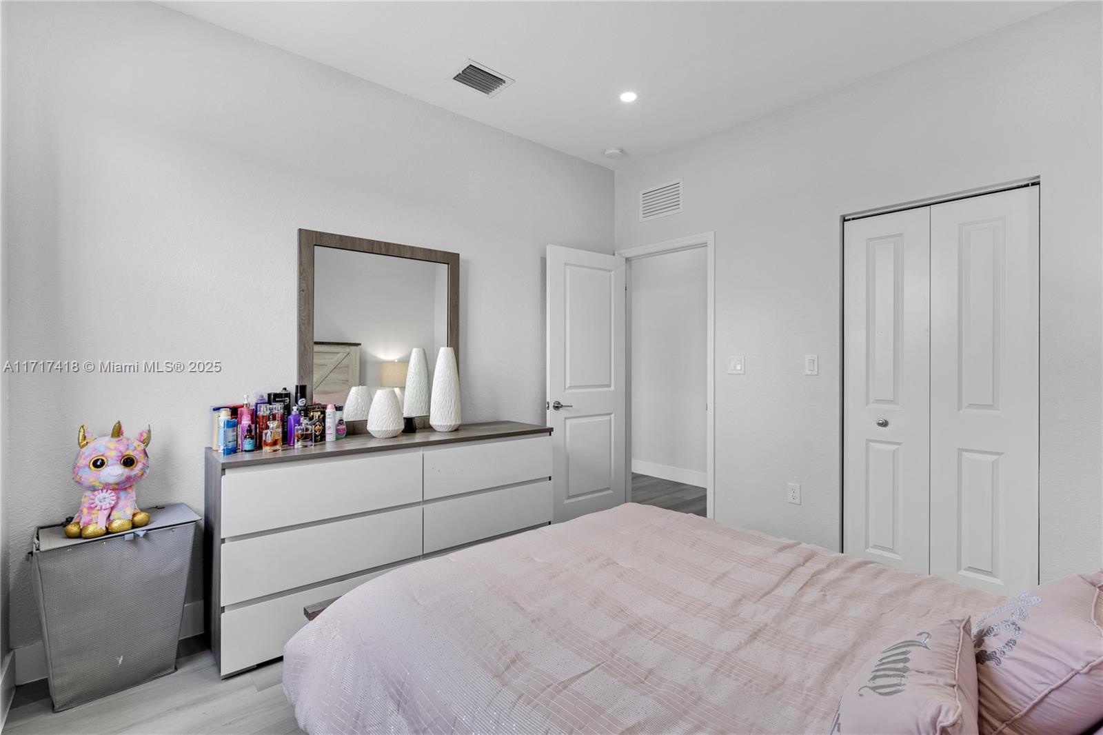 12953 Southwest 230th Street Miami, FL 33170 - Photo 32 of 49 a room with a bed and dresser