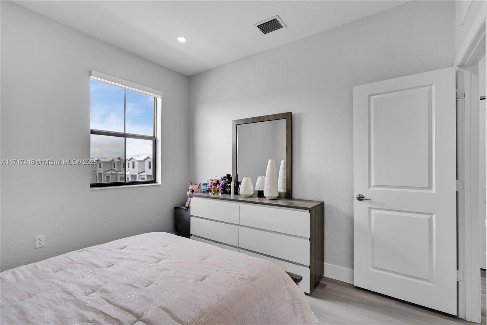 12953 Southwest 230th Street Miami, FL 33170 - Photo 33 of 49 a bedroom with a bed and a window