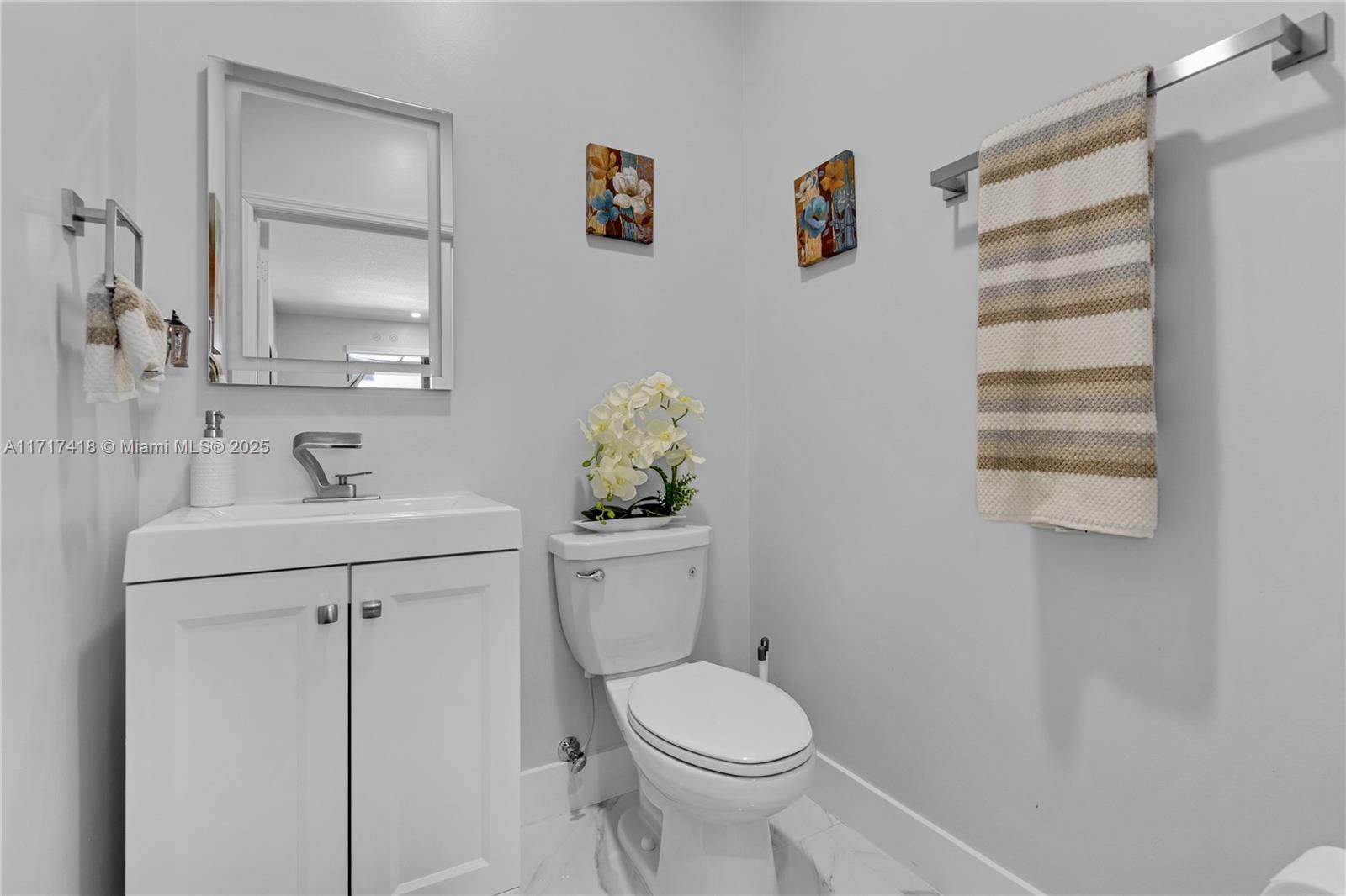 12953 Southwest 230th Street Miami, FL 33170 - Photo 35 of 49 a bathroom with a sink a toilet and mirror