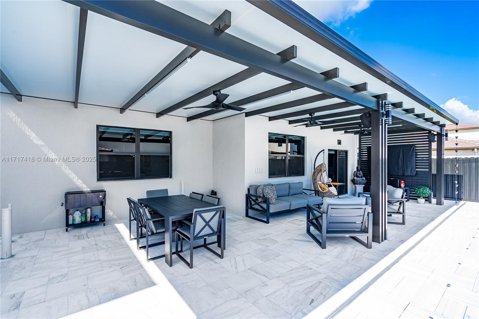 12953 Southwest 230th Street Miami, FL 33170 - Photo 40 of 49 a view of a patio with table and chairs