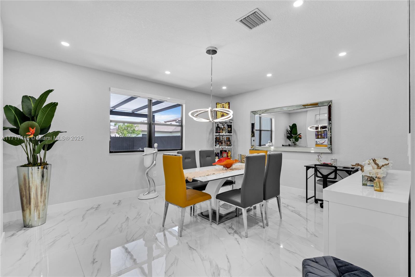 12953 Southwest 230th Street Miami, FL 33170 - Photo 6 of 49 a workspace with furniture and a potted plant