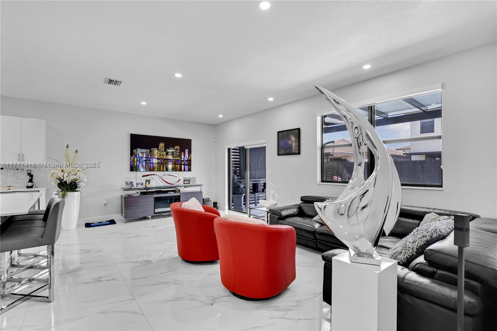 12953 Southwest 230th Street Miami, FL 33170 - Photo 9 of 49 a living room with furniture a flat screen tv and white walls