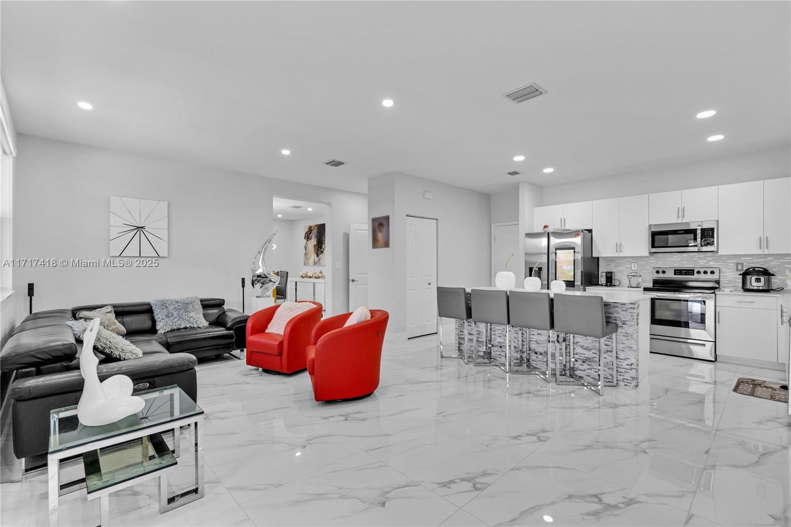 12953 Southwest 230th Street Miami, FL 33170 - Photo 10 of 49 a living room with furniture and kitchen view