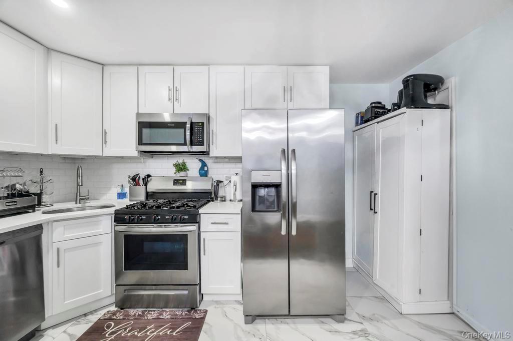 178-26 Zoller Road Queens, NY 11434 - Photo 11 of 26 a kitchen with stainless steel appliances cabinets and a counter top space