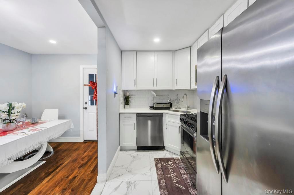 178-26 Zoller Road Queens, NY 11434 - Photo 12 of 26 a kitchen with stainless steel appliances granite countertop a refrigerator and a sink